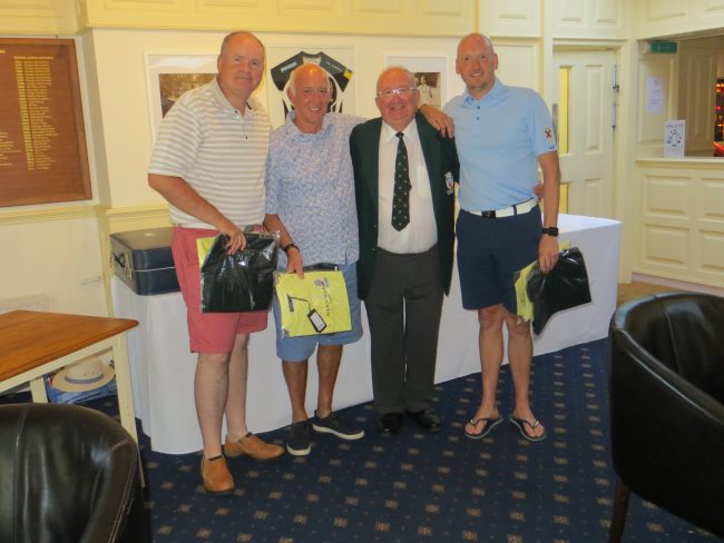 The winning team with the Captain, in mufti.